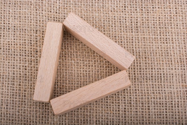 Wooden domino on a linen canvas background