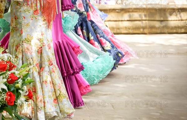 Group of women with unrecognizable backs wearing traditional dress from andalucia