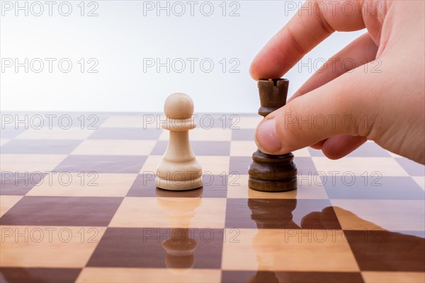 Person playing chess game making a move on board