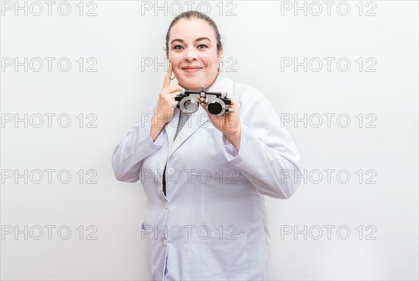 Smiling ophthalmologist holding a messbrille isolated. Portrait of optometrist holding a messbrille lens isolated