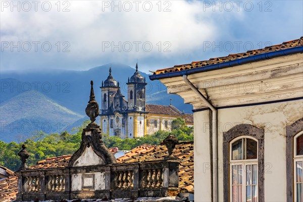 Facades of historic houses and churches with the mountains of the city of Ouro Preto in Minas Gerais