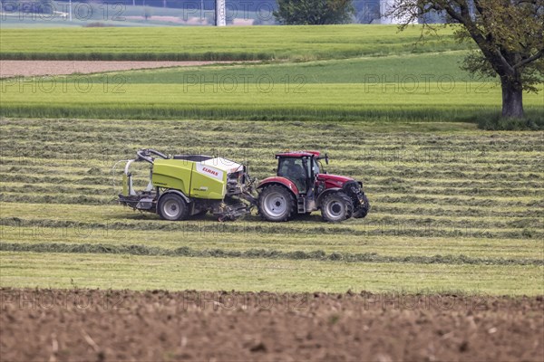 Farmer with tractor in a field in spring