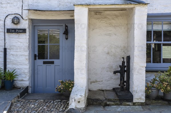 Historic 18th century cottage with cast iron swan pump