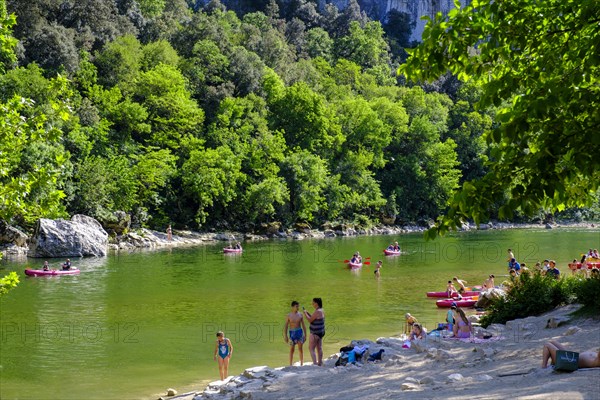 Kayaker and beach at the Pont d'Arc rock arch