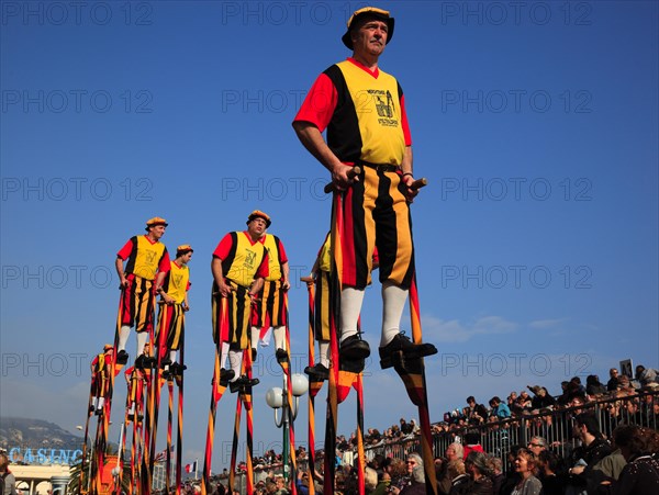 Stilt walkers in the street parade in Menton