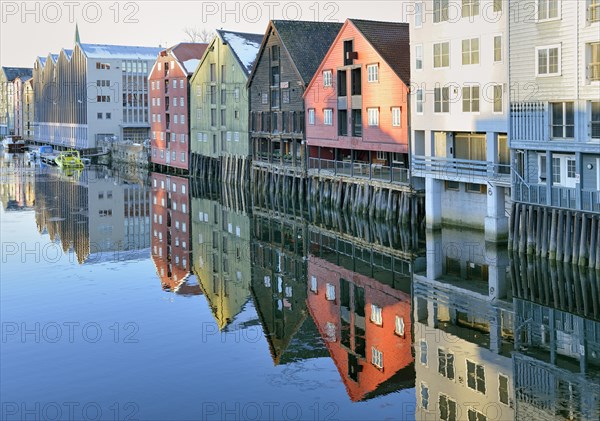 Historic wooden warehouses between modern new buildings