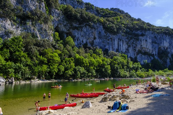 Kayaker and beach at the Pont d'Arc rock arch