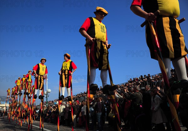 Stilt walkers in the street parade in Menton