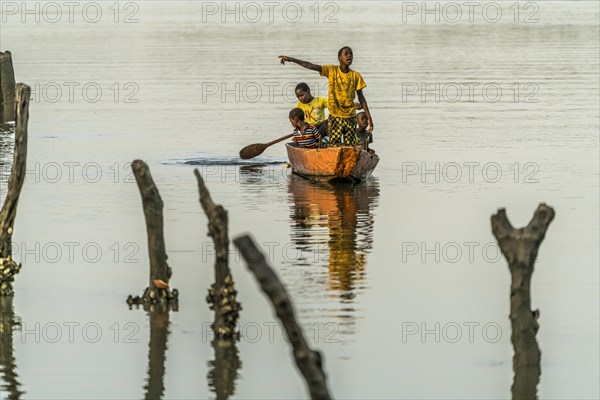 Children on a pirogue on the Gambia River