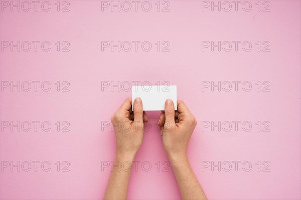 Person hands holding little paper