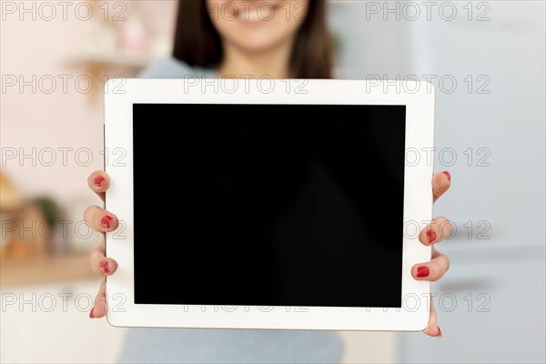 Close up woman holding tablet