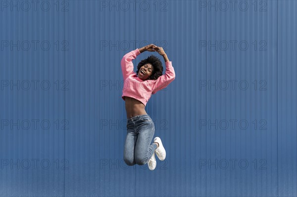 Portrait young beautiful female jumping