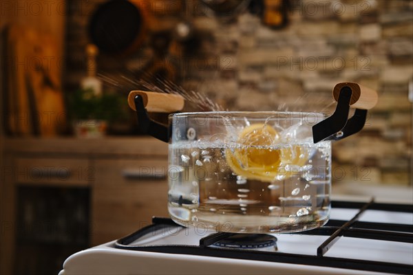 Drop fettuccine pasta into boiling water in a saucepan