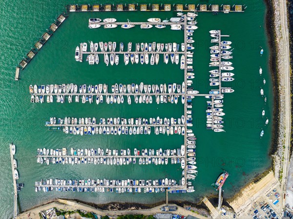 Top Down view over Boats and Yachts in Brixham Marina from a drone