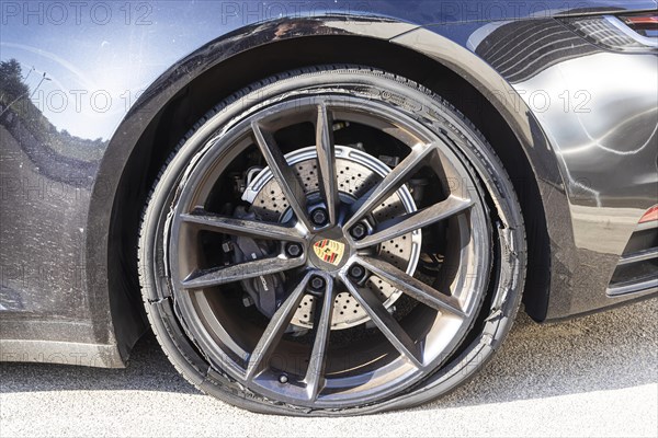 Burst tyre on a Porsche sports car