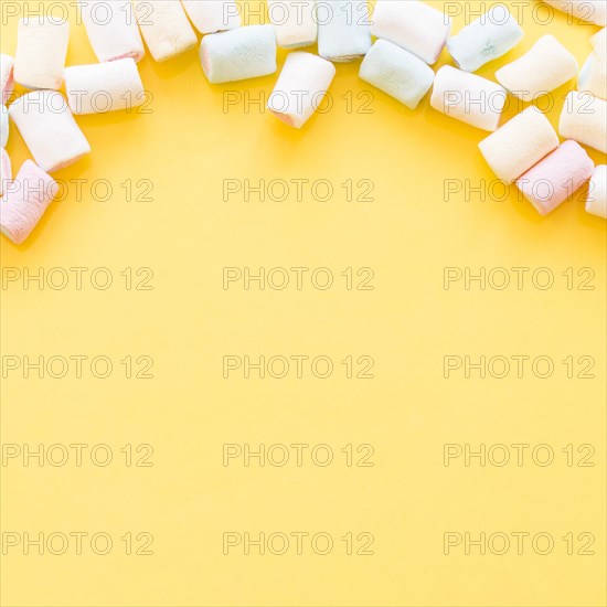 Soft marshmallows edge yellow background