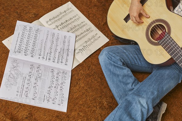 Girl playing guitar home