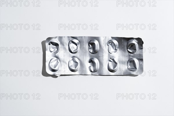 Empty tablet blister pack against white background