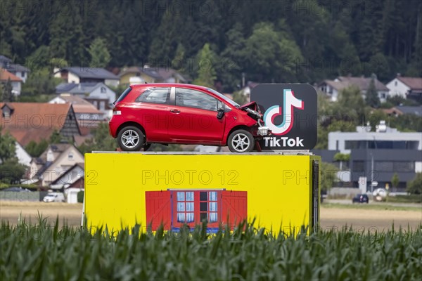 Accident vehicle on a pedestal in a maize field