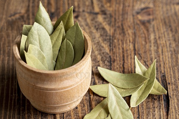 High angle wooden bowl with bay leaves