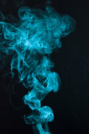 Beautiful blue smoke pattern spread black backdrop