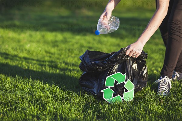 Recycle concept with woman collecting trash