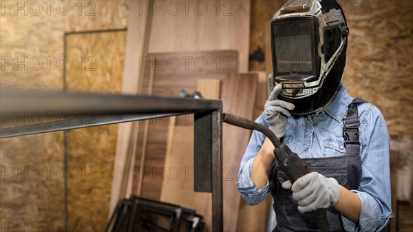 Front view woman with welding tool mask