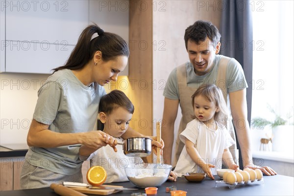 Medium shot happy family cooking