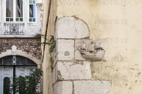 Relief of a sailing ship on a house wall in Lisbon