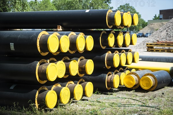 A stack of new pipes for district heating at a construction site in Duesseldorf