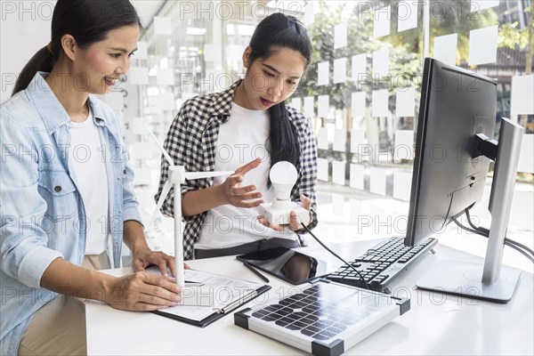 Asian women working together electrical project