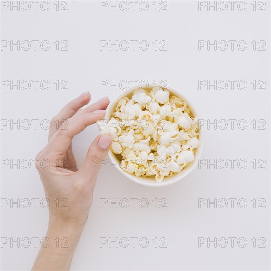 Top view hand picking salted popcorn