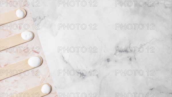 Wooden sticks with cream marble background