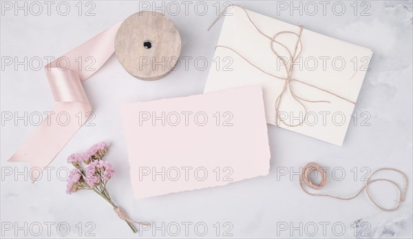 Flat lay lovely arrangement with wedding invitations