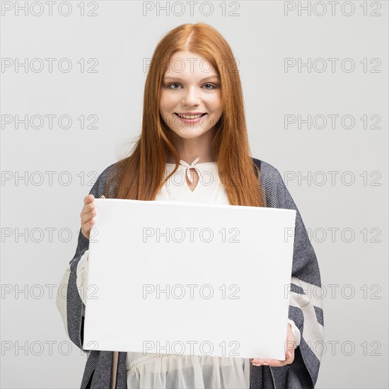 Medium shot woman holding canvas