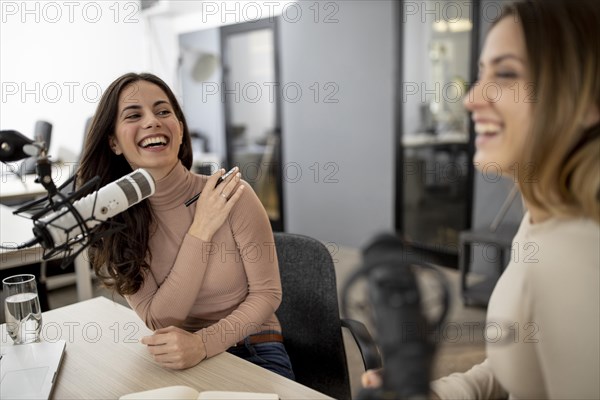 Two women broadcasting radio together