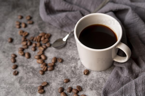 Cup coffee with coffee beans spoon