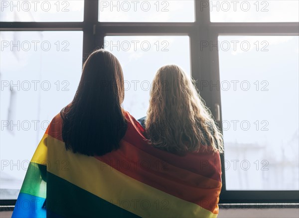 Lesbian sweethearts wrapped lgbt flag