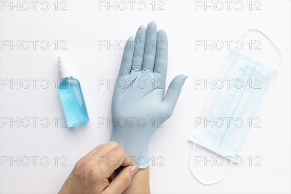 Top view hand putting glove with hand sanitizer medical mask 1
