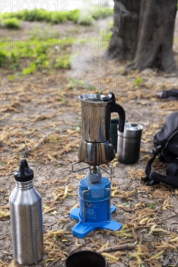 An espresso maker on a camping gas barbecue