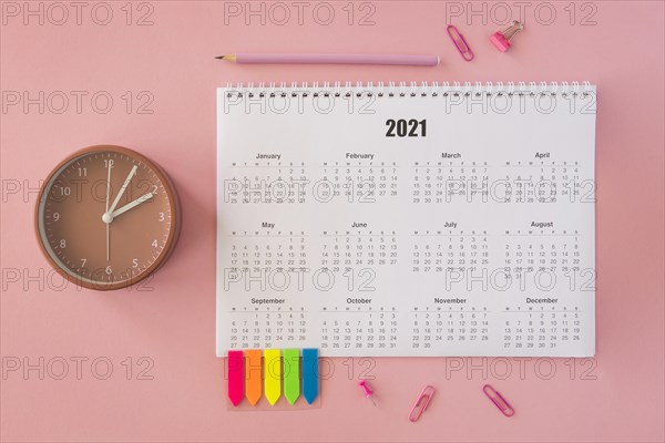 Flat lay desk calendar pink background