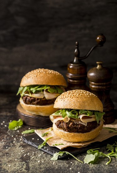 Front view fresh beef burgers with bacon slate board 1