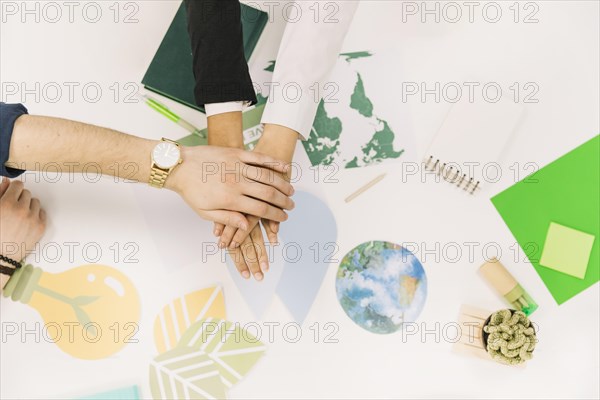 Group businesspeople stacking their hands desk