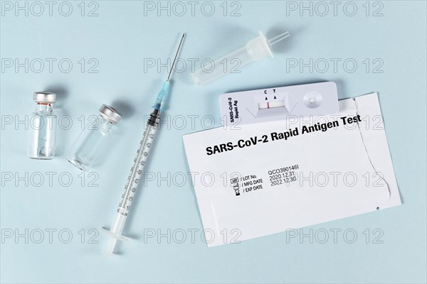 Tools to fight Corona Virus pandemic including rapid antigen test and vaccine vials with syringe