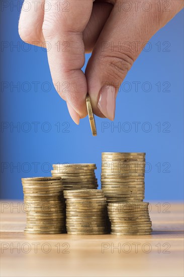 Person placing coin pile coins