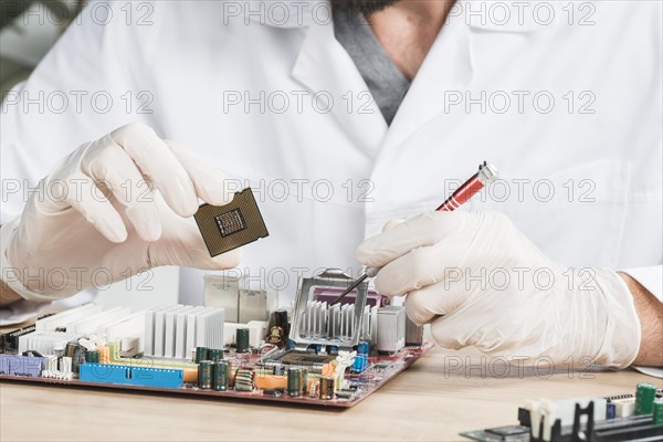 Close up male technician holding computer chip