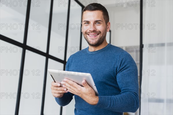 Low angle smilet man with tablet