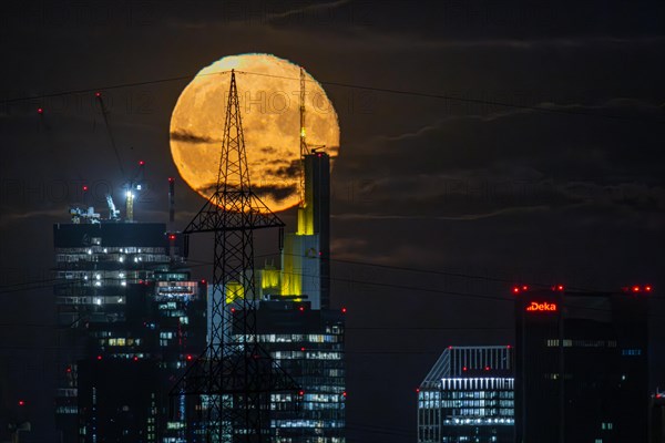 The super full moon rises behind the Frankfurt bank skyline