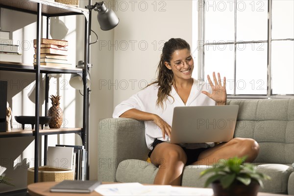 Female sitting couch laptop