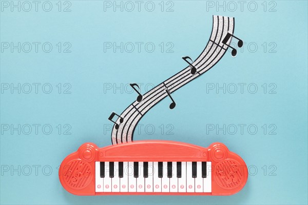 Top view piano toy with blue background